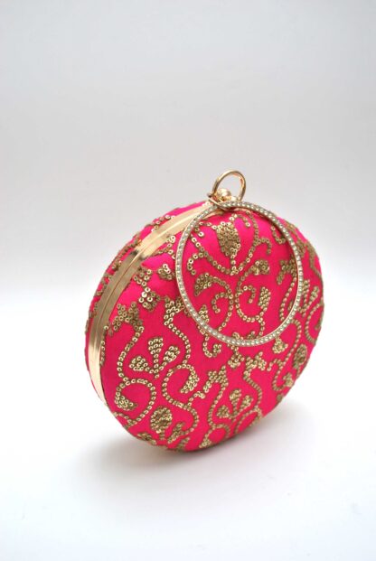 Clutch redondo fucsia